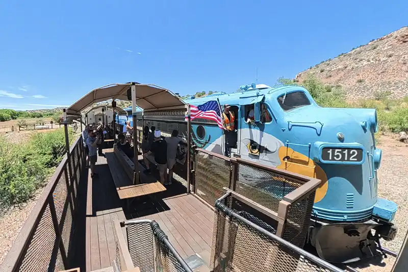 Verde Canyon Railroad Conductor Holding American Flag